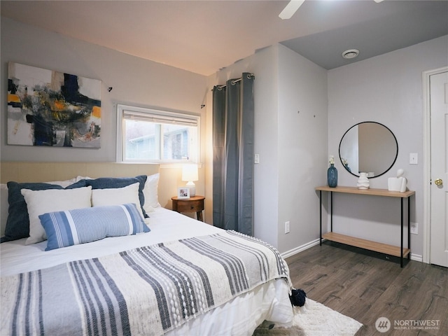 bedroom featuring a ceiling fan, dark wood-style floors, and baseboards