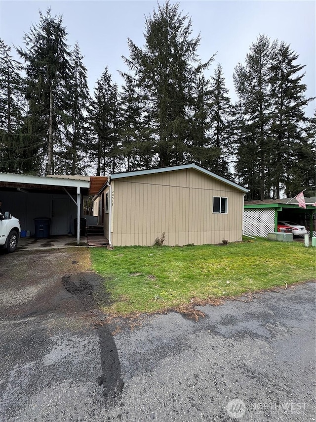 exterior space with aphalt driveway and a carport