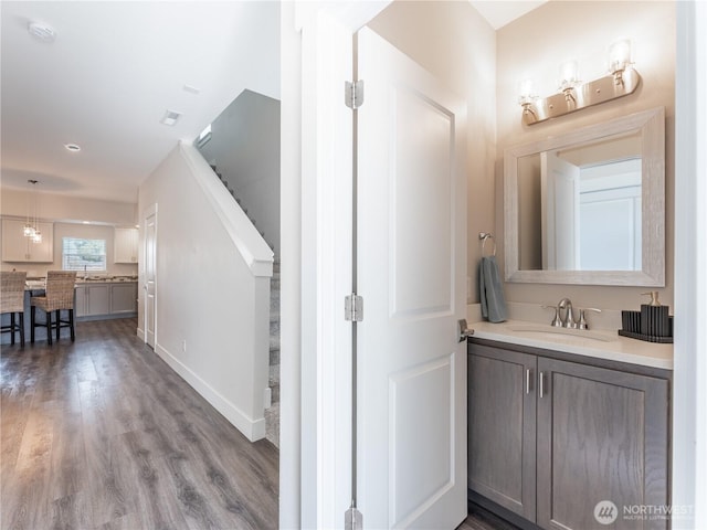 bathroom featuring wood finished floors and vanity