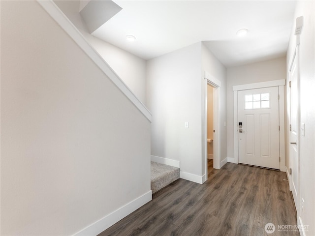 foyer featuring stairs, wood finished floors, and baseboards