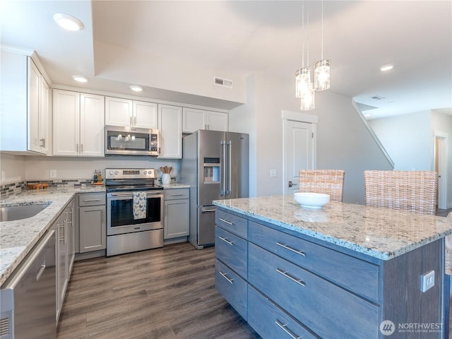 kitchen with dark wood-style floors, visible vents, recessed lighting, white cabinets, and appliances with stainless steel finishes