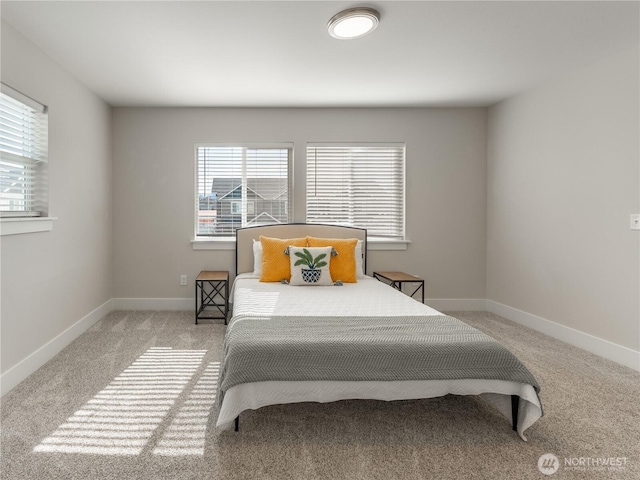 carpeted bedroom with baseboards and multiple windows