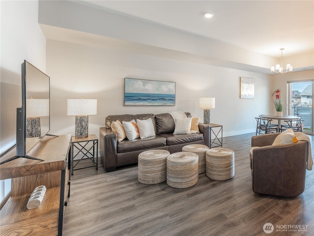 living room with baseboards, an inviting chandelier, and wood finished floors