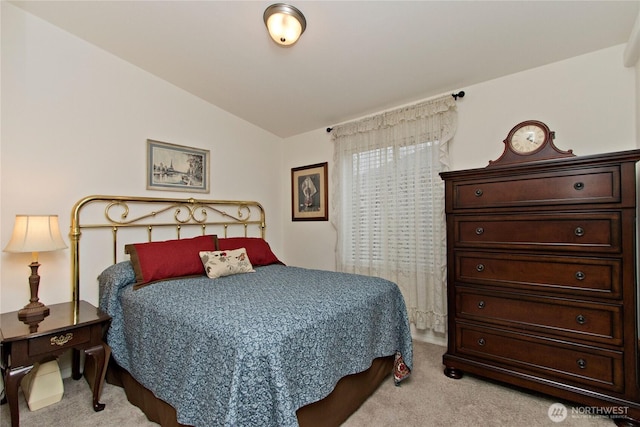 bedroom with carpet floors and vaulted ceiling