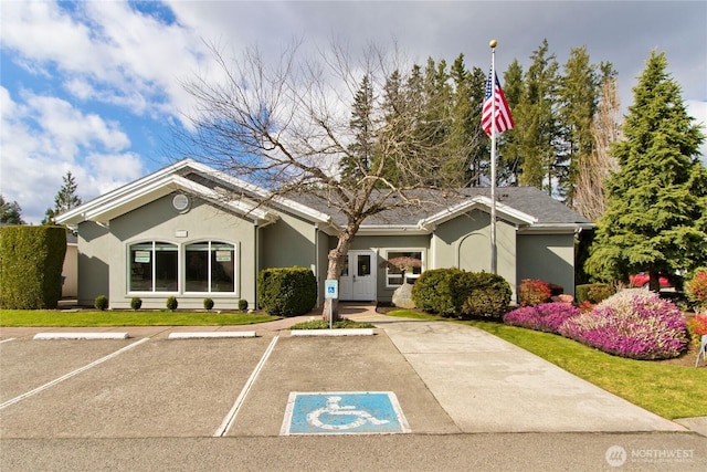 ranch-style house with uncovered parking