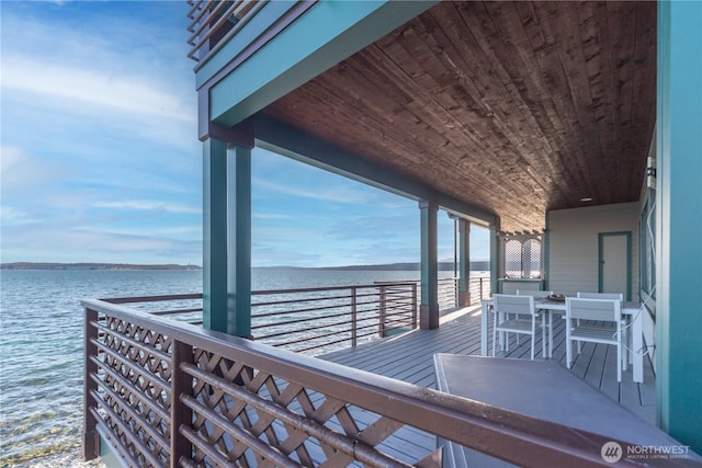 wooden terrace featuring a water view