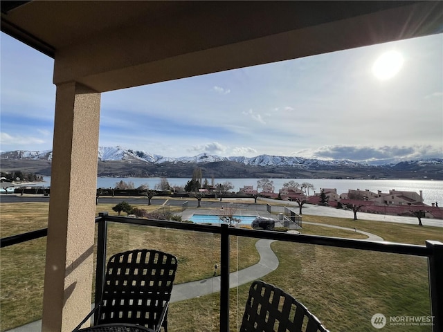 balcony with a water and mountain view