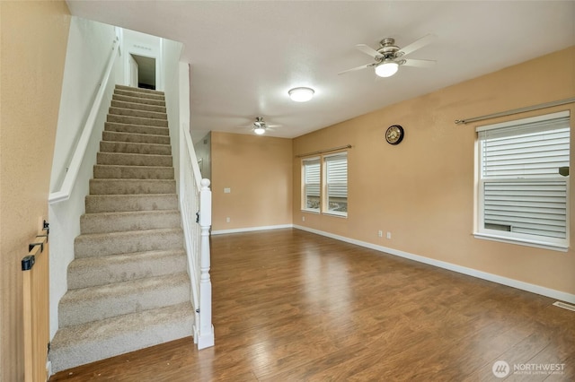 stairway with visible vents, baseboards, a ceiling fan, and wood finished floors