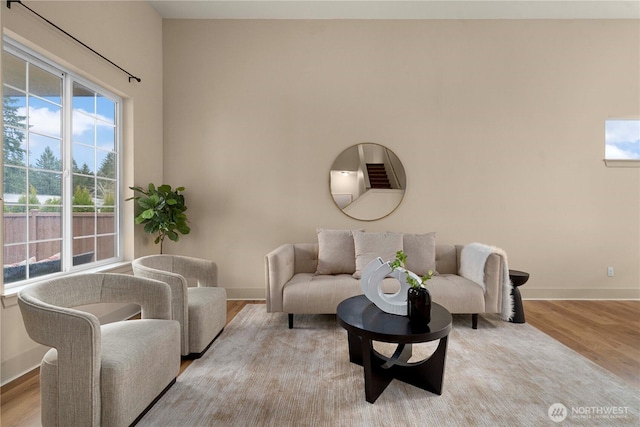 living area featuring baseboards and wood finished floors