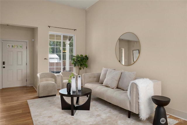 living room with baseboards and light wood finished floors