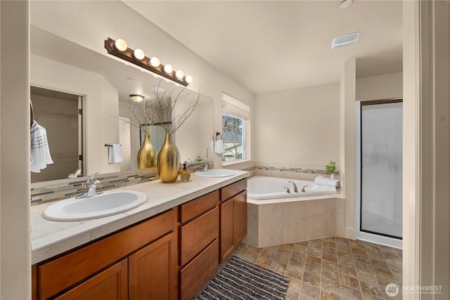 full bath featuring a sink, visible vents, a garden tub, and a shower stall