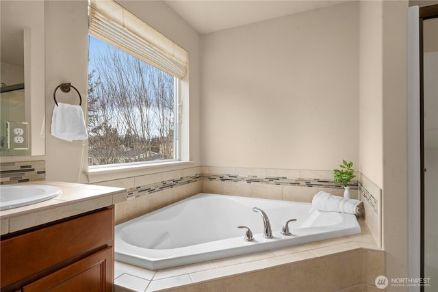 full bathroom featuring a bath and vanity