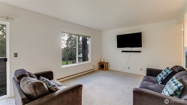 carpeted living room featuring a baseboard heating unit and plenty of natural light