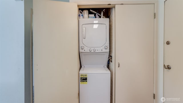 laundry room featuring laundry area and stacked washer / dryer