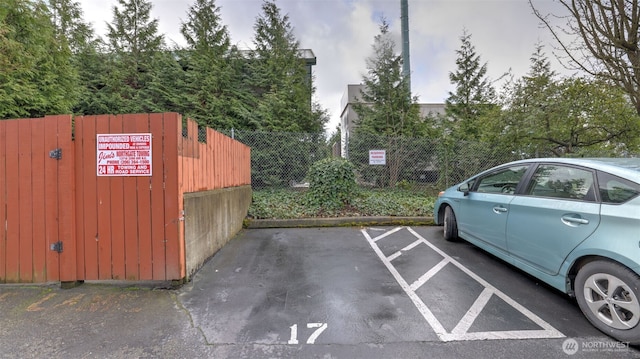 uncovered parking lot with a gate and fence