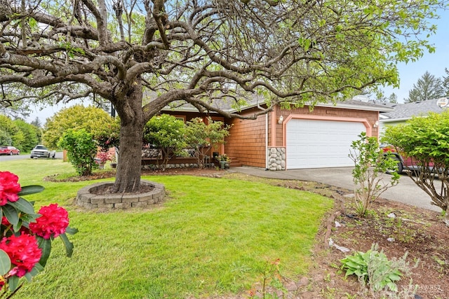 view of front of property with a garage, a front yard, driveway, and stone siding
