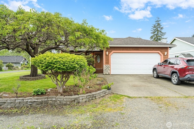 ranch-style home with roof with shingles, an attached garage, stone siding, a front yard, and concrete driveway
