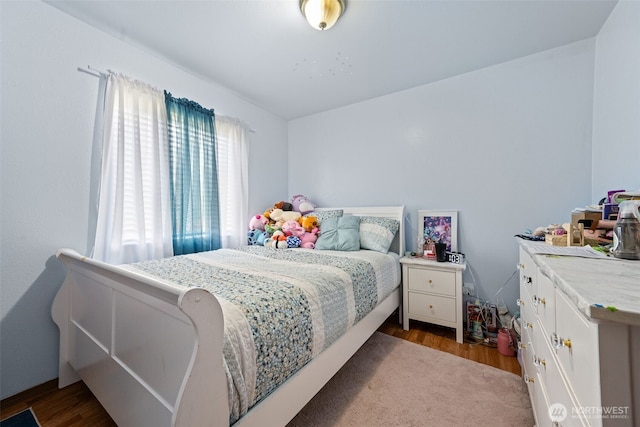 bedroom featuring wood finished floors