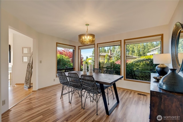 1200 Viewland Way, Edmonds, WA 98020 - dining room with healthy amount of natural light, light wood finished floors, a chandelier, and baseboards