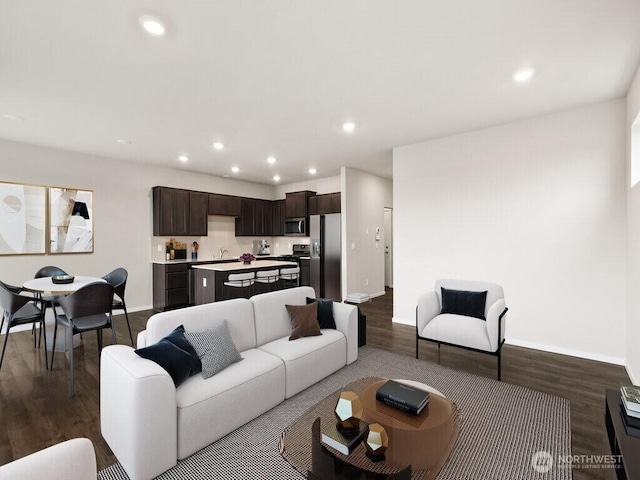 living area with recessed lighting, baseboards, and dark wood-type flooring