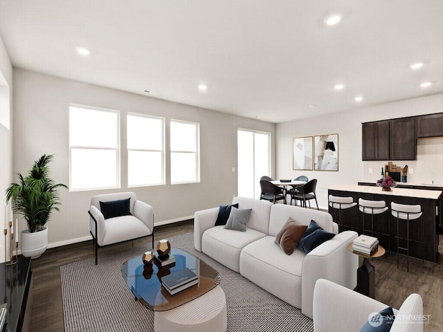 living room with recessed lighting, baseboards, a healthy amount of sunlight, and dark wood-style flooring