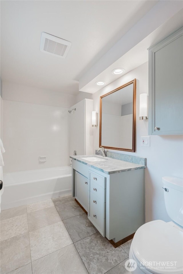 bathroom with visible vents, toilet, bathtub / shower combination, and vanity