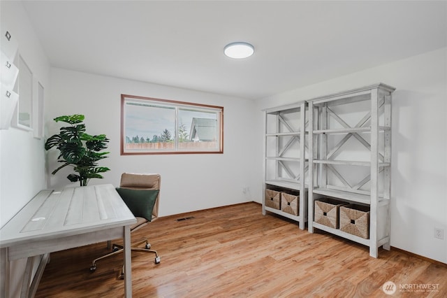 office featuring light wood finished floors and visible vents