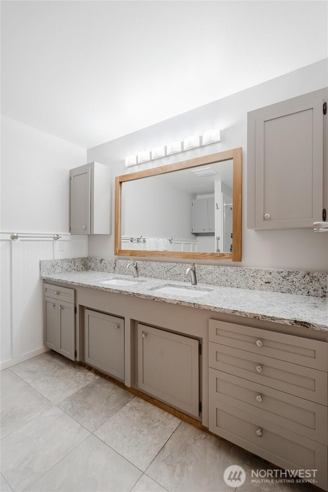 bathroom featuring vanity and a wainscoted wall