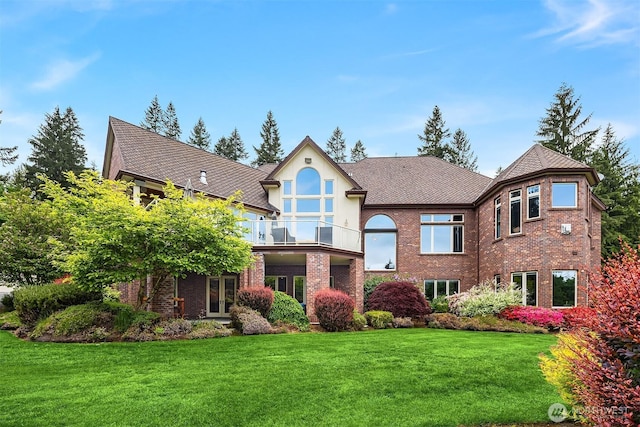 18212 244th Ave NE, Woodinville, WA 98077 - view of front of home with a front yard, a balcony, brick siding, french doors, and stucco siding