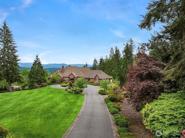18212 244th Ave NE, Woodinville, WA 98077 - view of front facade with a front yard and a mountain view