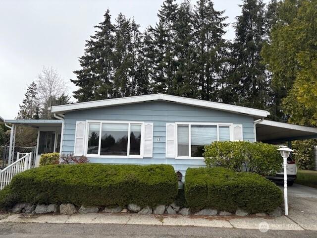 view of side of home with an attached carport