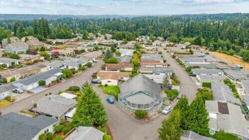 drone / aerial view with a view of trees and a residential view