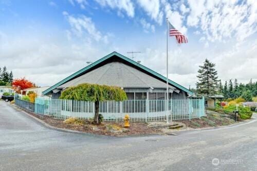 view of home's exterior featuring fence and a sunroom