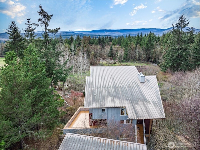 drone / aerial view featuring a mountain view and a wooded view