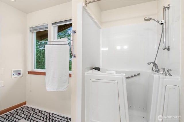 clothes washing area with a wealth of natural light, baseboards, hookup for a washing machine, and laundry area