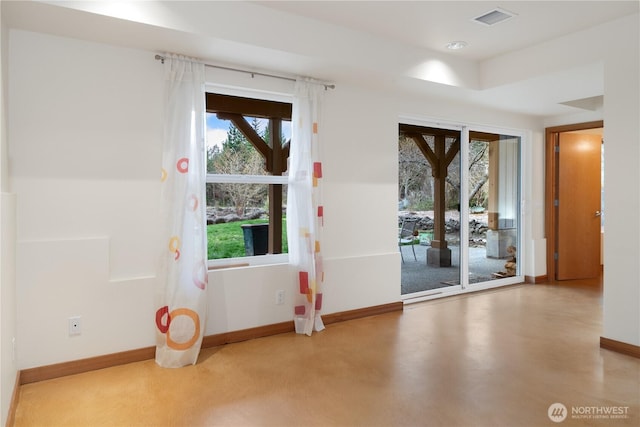 entryway featuring finished concrete flooring, baseboards, and visible vents