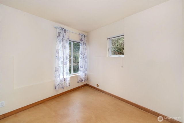 empty room featuring baseboards