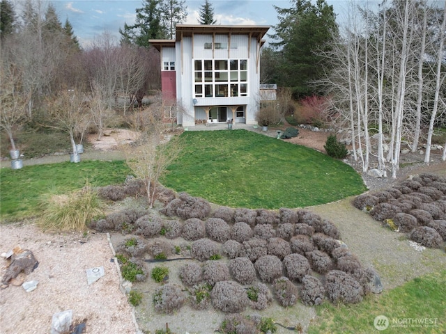 rear view of house featuring a yard