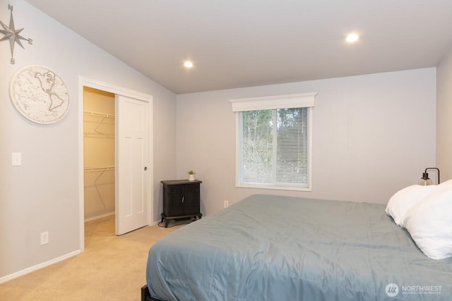 bedroom featuring recessed lighting, a closet, light carpet, and a spacious closet