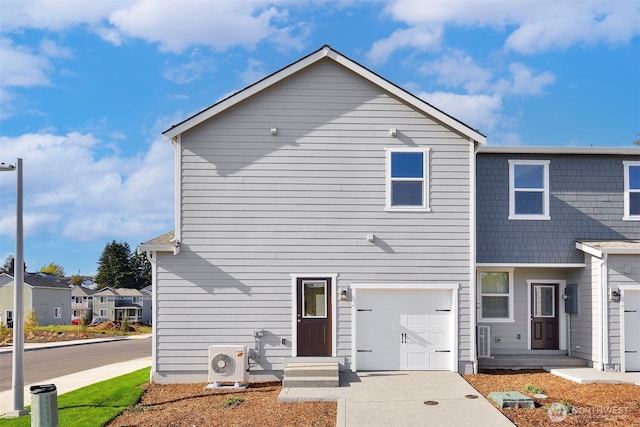 view of front of home featuring entry steps, ac unit, a garage, and driveway