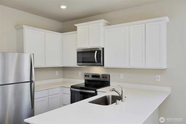 kitchen featuring a sink, appliances with stainless steel finishes, and light countertops