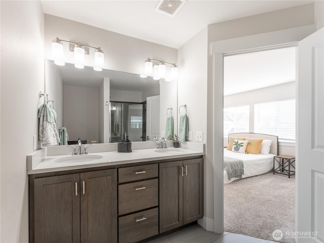 ensuite bathroom with double vanity, visible vents, ensuite bath, and a sink