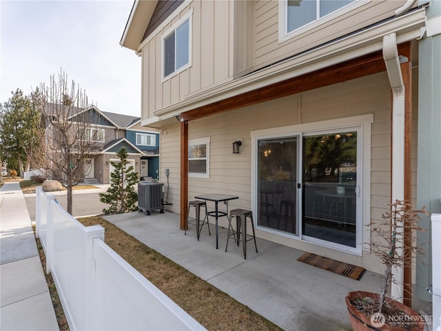 view of patio / terrace featuring central AC unit and fence