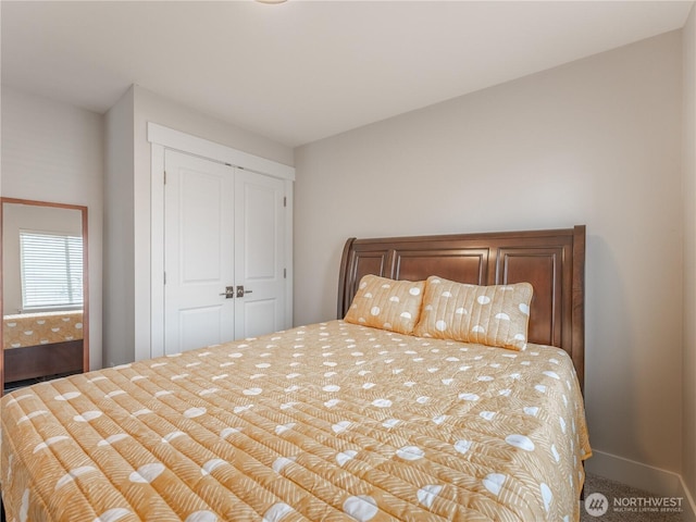 bedroom with a closet, baseboards, and carpet