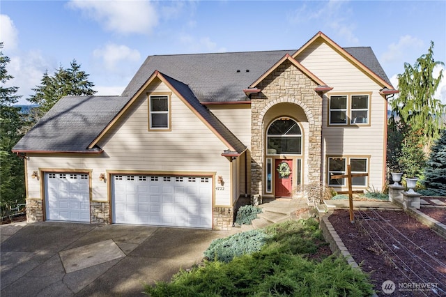 view of front facade featuring a garage, stone siding, driveway, and a shingled roof