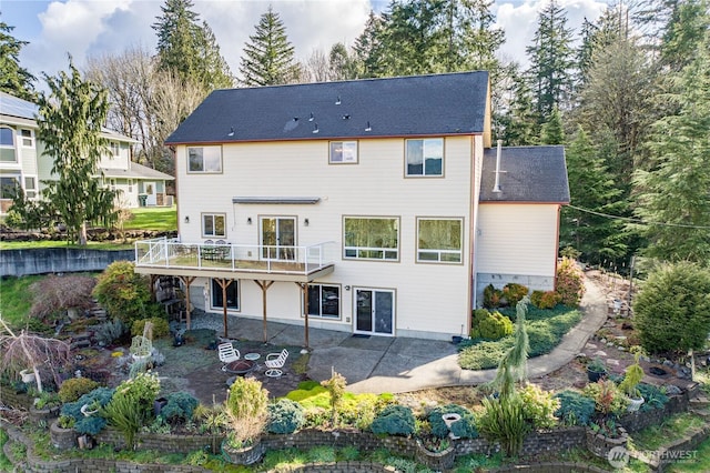 back of house with a patio area and a wooden deck