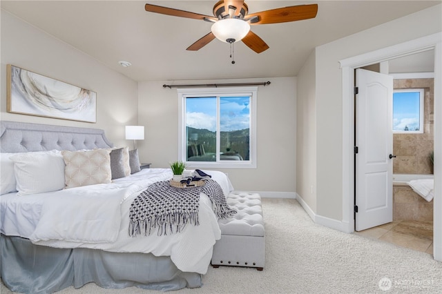 carpeted bedroom featuring baseboards and ceiling fan