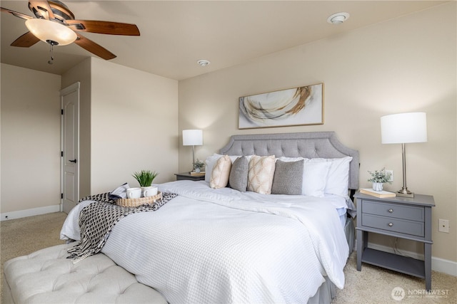 carpeted bedroom with a ceiling fan and baseboards