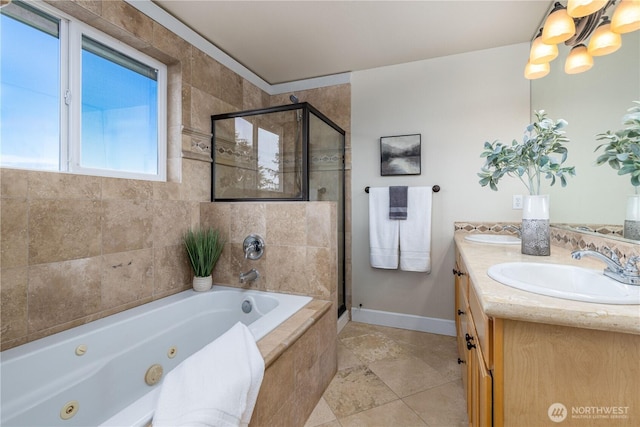 bathroom with double vanity, a notable chandelier, a stall shower, and a sink