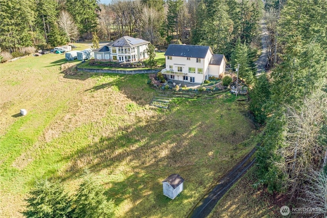 drone / aerial view featuring a wooded view